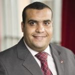 headshot of Mostafa Ghanem, man in suite and tie