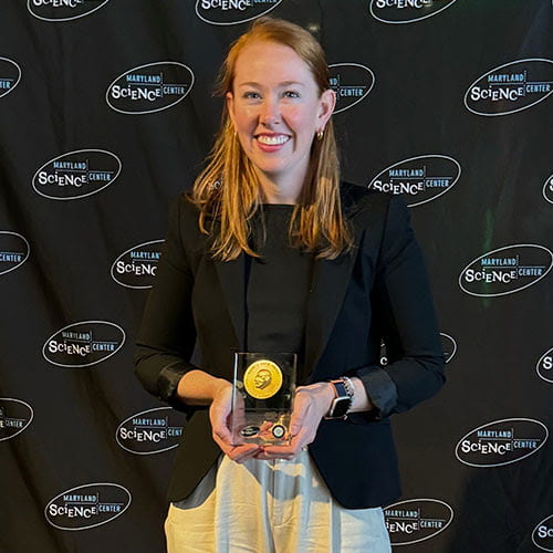 woman holding an award