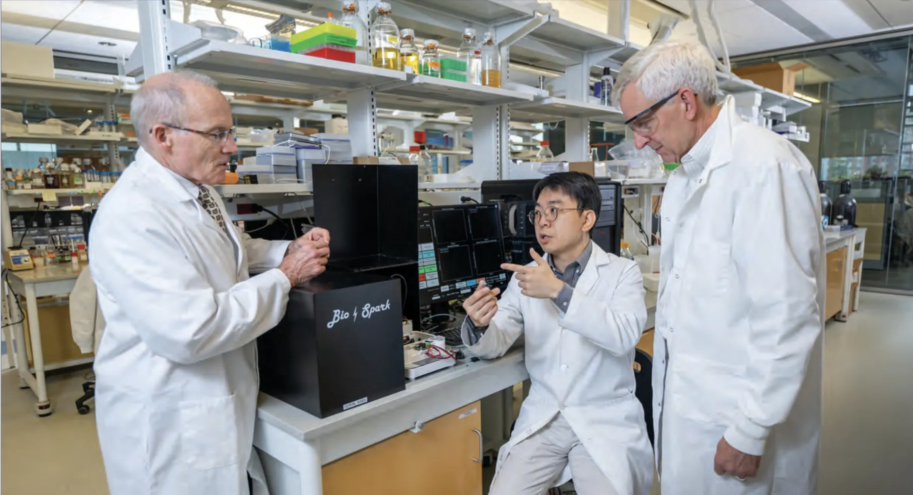 three men in a laboratory 